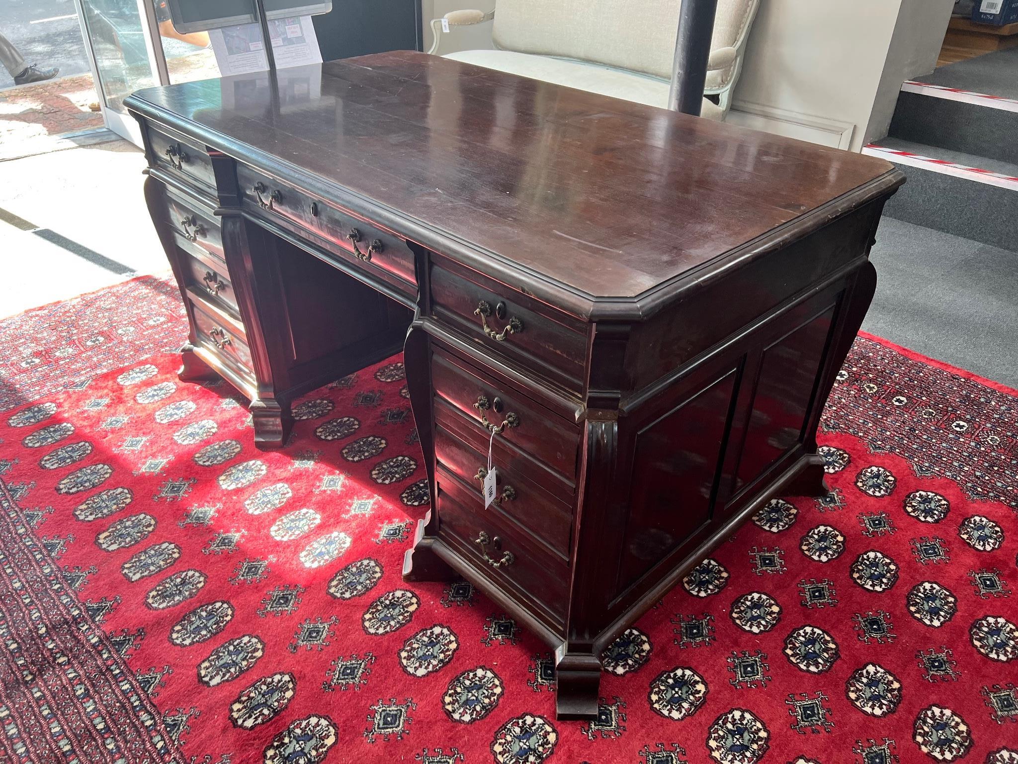 An early 20th century continental mahogany pedestal desk fitted nine drawers width 154cm depth 88cm, height 80cm